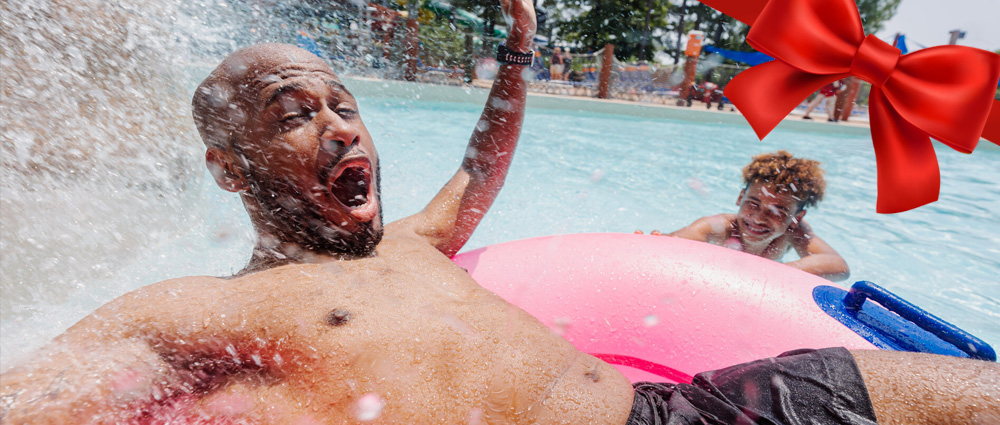 Son splashing his Dad in the wave pool